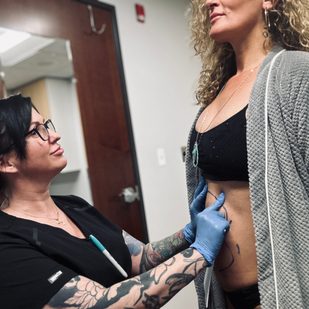 Woman with stubborn belly fat being assessed around the abdomen and flanks. Treatment in Portland.